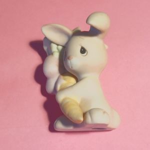 Enesco Bunny is holding his bounty from a vegetable garden. Johnathan and David